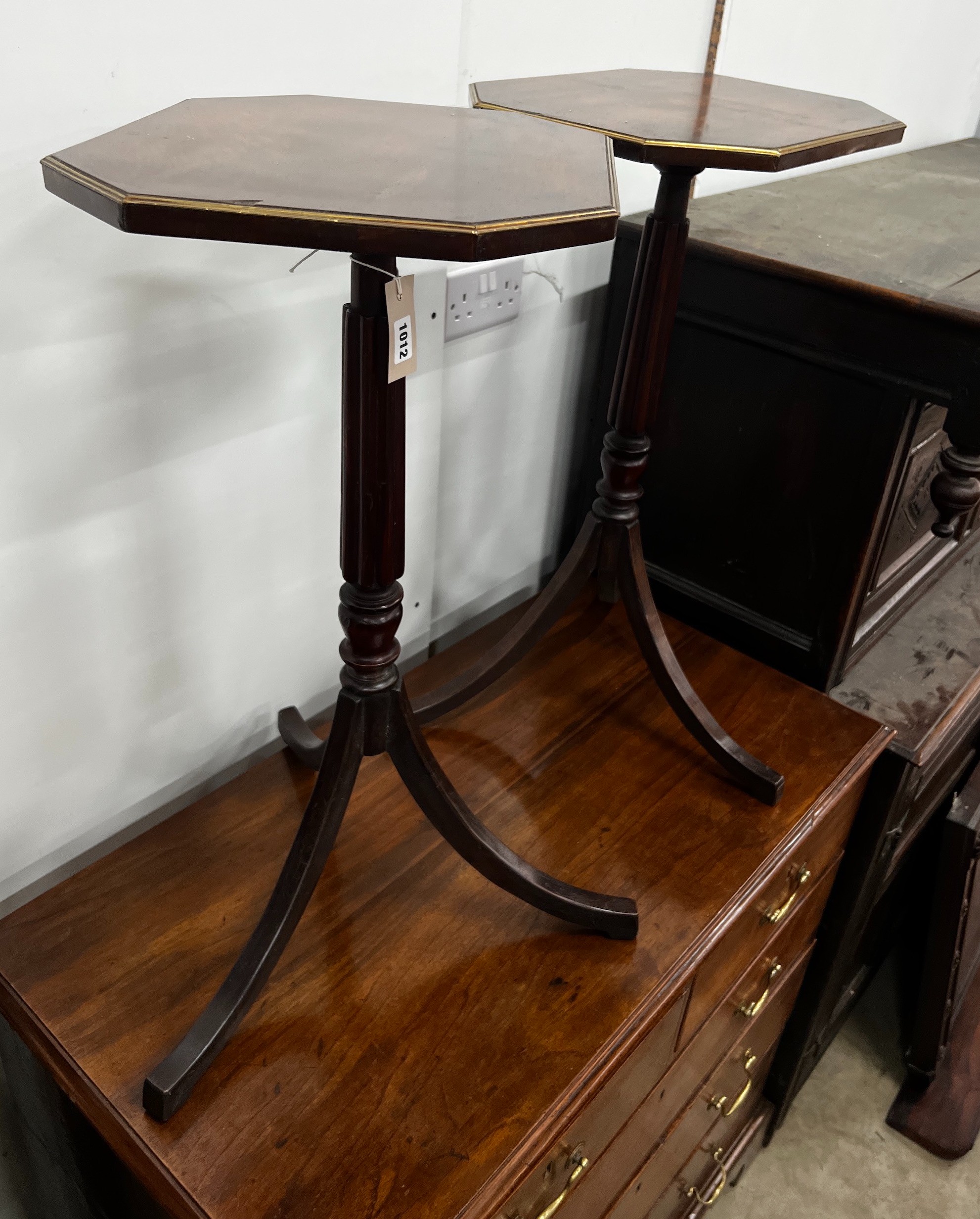 A pair of Regency style brass mounted mahogany octagonal top tripod tables, width 39cm, depth 32cm, height 71cm